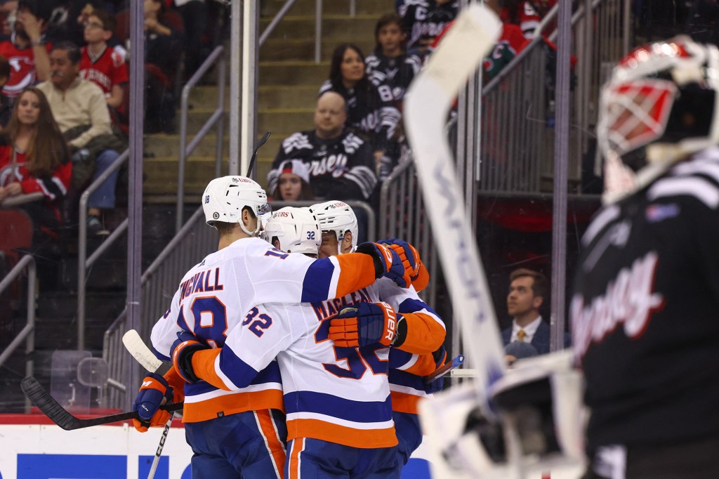 The Islanders celebrates Kyle MacLean's third-period goal during their win Monday against the Devils.