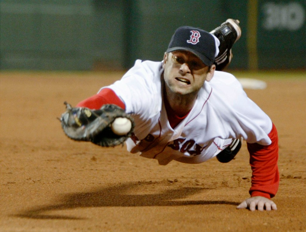 Boston Red Sox first baseman David McCarty dives and knocks down a ball hit down the first base line by Cleveland's Matt Lawton in the eighth inning at Fenway Park in Boston, Massachusetts May 10, 2004.