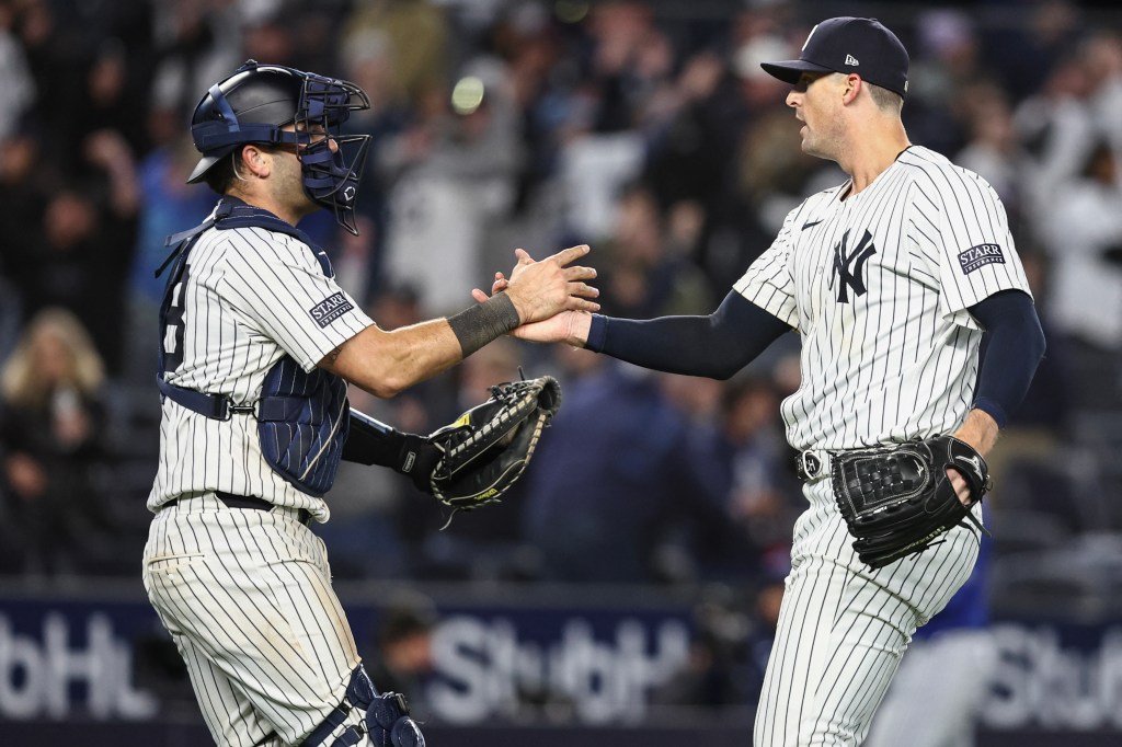 Austin Wells (left) congratulates closer Clay Holmes after a Yankees' win earlier in the season.