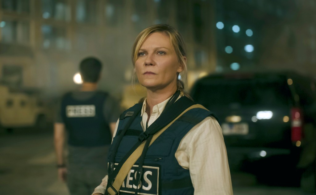 Kirsten Dunst in a scene from the film 'Civil War', wearing a vest