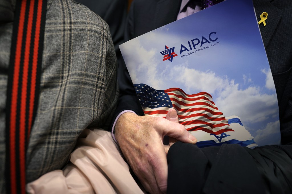 A visitor holds an AIPAC folder in an elevator in Rayburn House Office Building on March 12, 2024 on Capitol Hill in Washington, DC