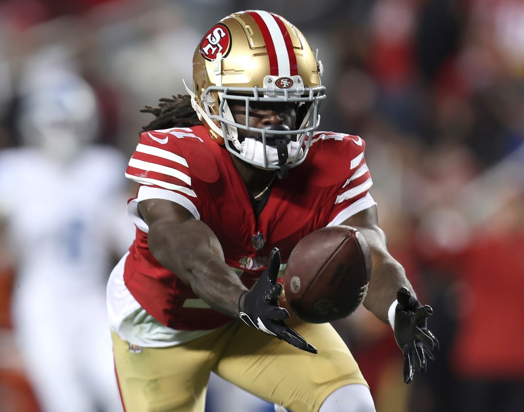 San Francisco 49ers wide receiver Brandon Aiyuk catches a pass against the Detroit Lions during the second half of the NFC Championship NFL football game in Santa Clara, Calif., Jan. 28, 2024. Aiyuk is staying away from the 49ers facility at the start of the offseason program as he seeks a lucrative long-term contract. 