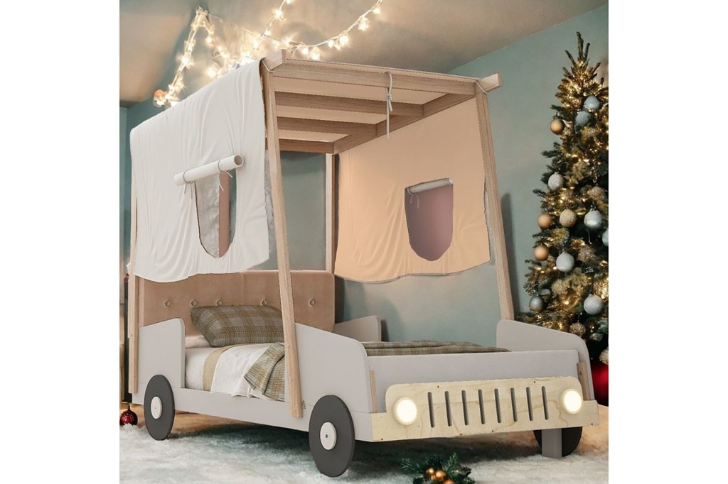 A bed with a canopy and a Christmas tree