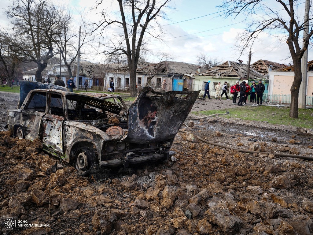 A destroyed car and damaged residential buildings are seen at the site of a Russian missile strike, amid Russia's attack on Ukraine, in Mykolaiv, Ukraine March 17, 2024. 