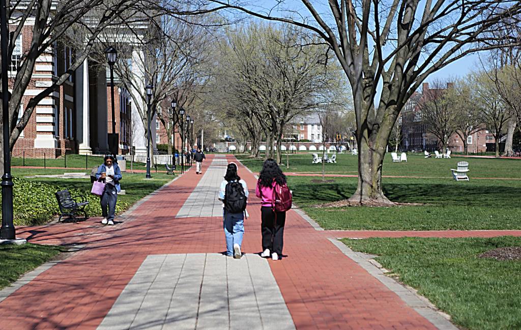 Shukria and Khadija walking on The Green at the University of Delaware, two refugees from Afghanistan after the Taliban takeover