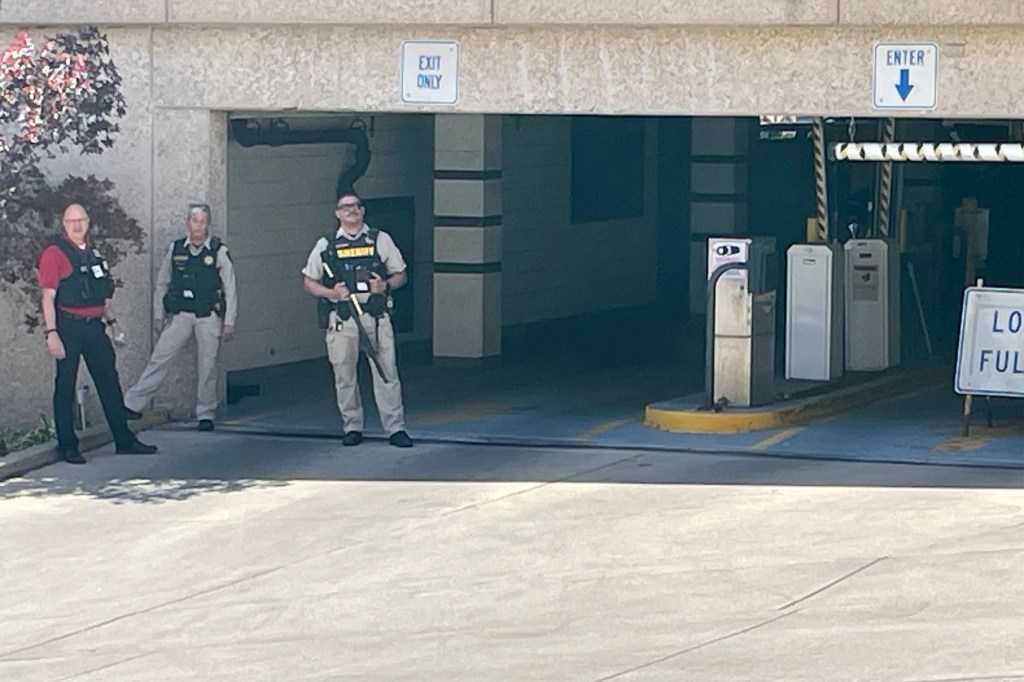 Police stand outside the area where the hostage was held.