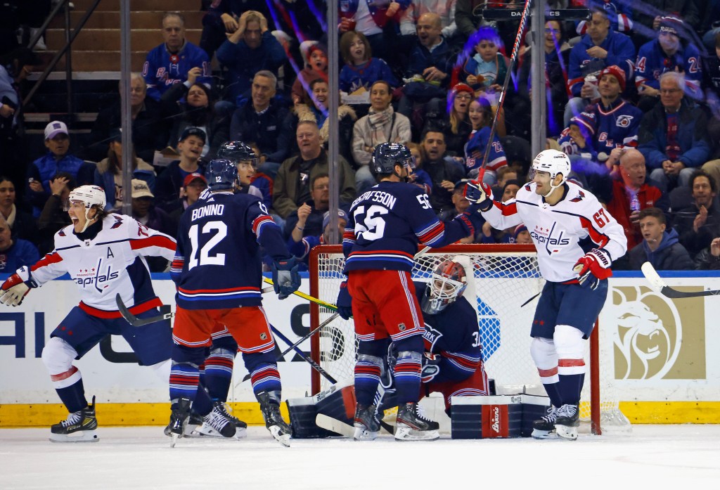 T.J. Oshie #77 of the Washington Capitals (L) scores a second period goal against Igor Shesterkin #31 of the New York Rangers at Madison Square Garden on January 14, 2024 in New York City. 