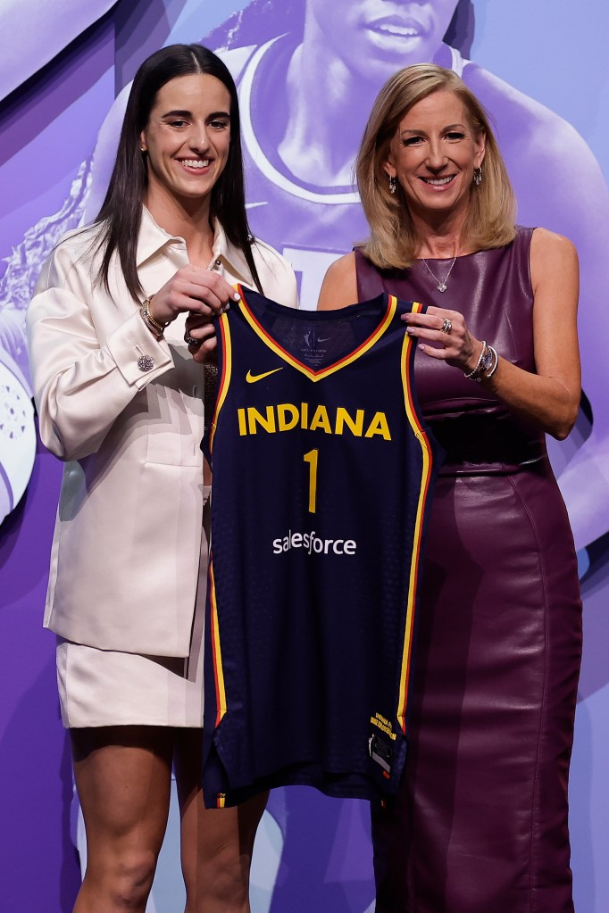 Iowa's Caitlin Clark, left, poses for a photo with WNBA commissioner Cathy Engelbert, right, after being selected first overall by the Indiana Fever during the first round of the WNBA basketball draft