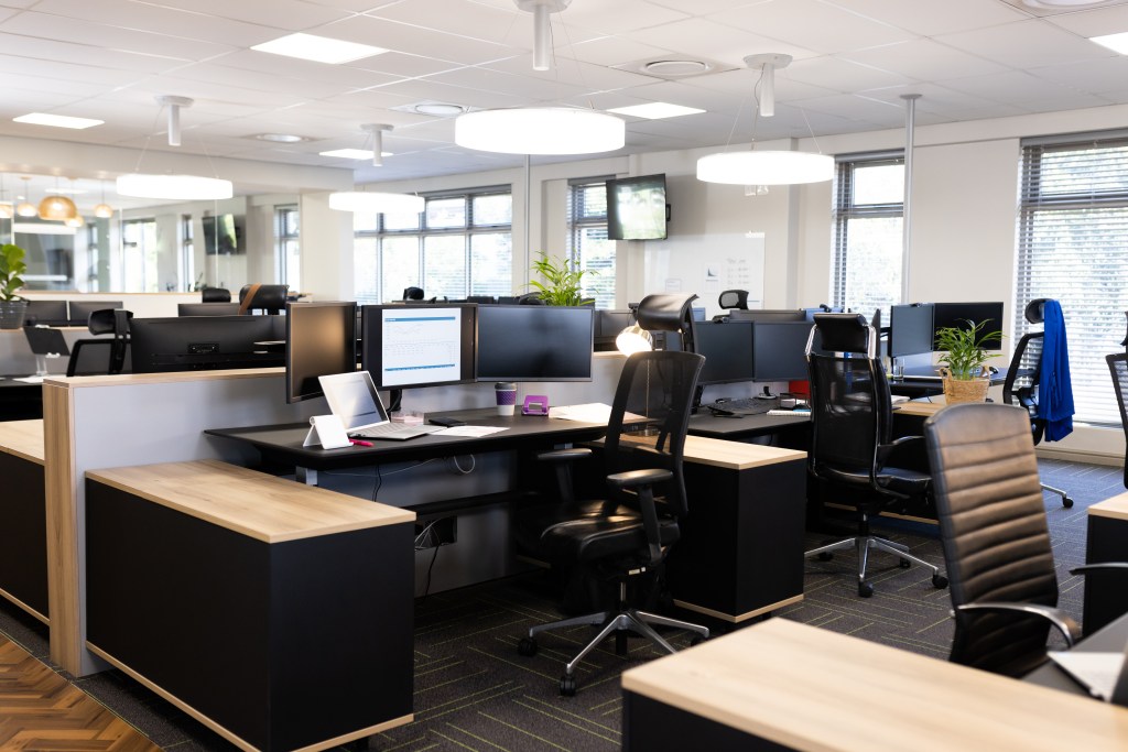 Open office space with desks, chairs, and computers