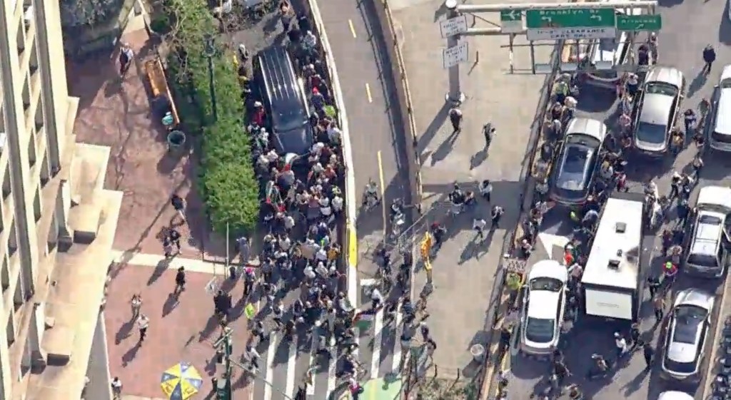 Pro-Palestinian protesters crossing the Manhattan bound Brooklyn Bridge on April 15, 2024.