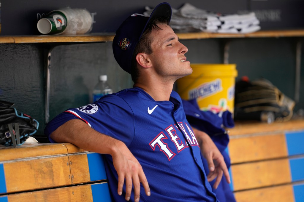 Jack Leiter looks on from the dugout after getting pulled in the fourth inning of the Rangers' 9-7 win over the Tigers.