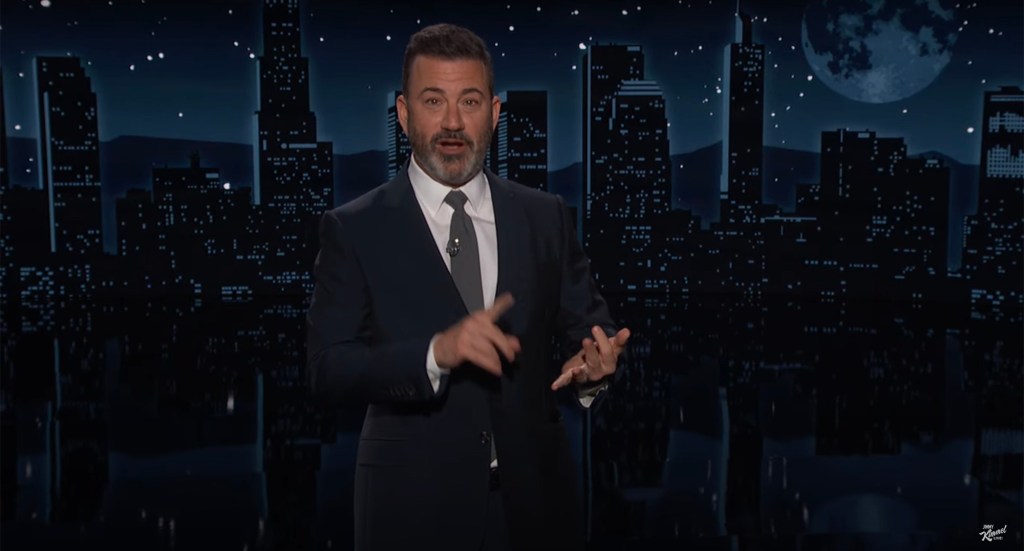 Jimmy Kimmel in a suit and tie, expressing shock over his discoveries in Japan