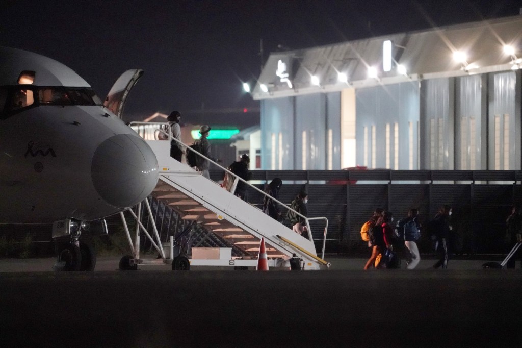 Immigrants from the southern border disembarking from a World Atlantic Airlines airplane and boarding charter buses at Westchester County Airport in White Plains, NY.