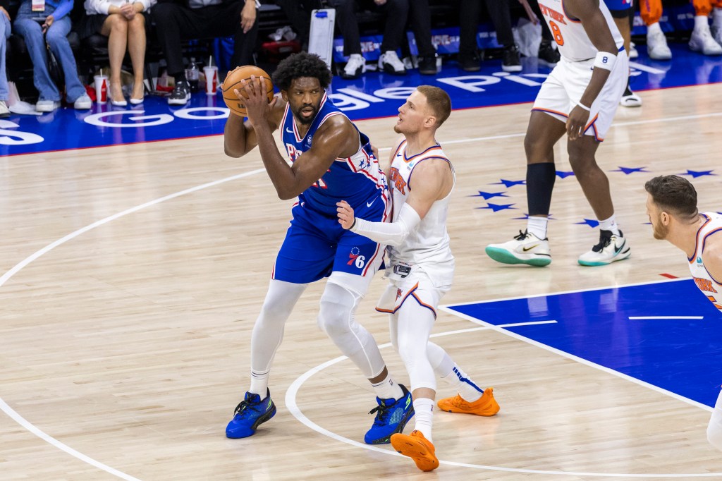 Donte DiVincenzo #0 of the New York Knicks is miss matched as he defends against Joel Embiid #21 of the Philadelphia 76ers