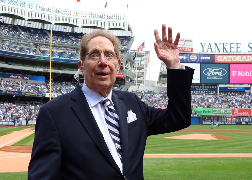 John Sterling waves to the crowd while he is honored by the Yankees in a pre-game ceremony as he retires