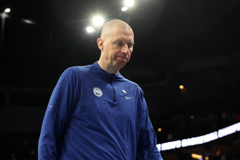 Head coach Mark Pope of Brigham Young Cougars looking disappointed as he walks off the court after a defeat in the NCAA Men's Basketball Tournament