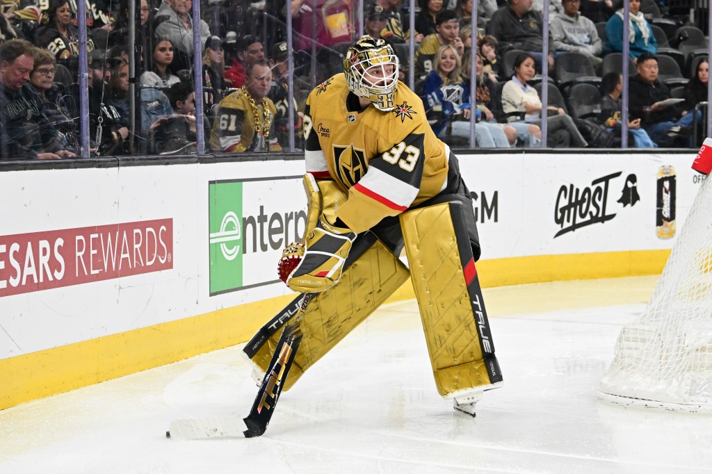 .Adin Hill #33 of the Vegas Golden Knights controls a loose puck against the Columbus Blue Jackets in the third period at T-Mobile Arena on March 23, 2024.