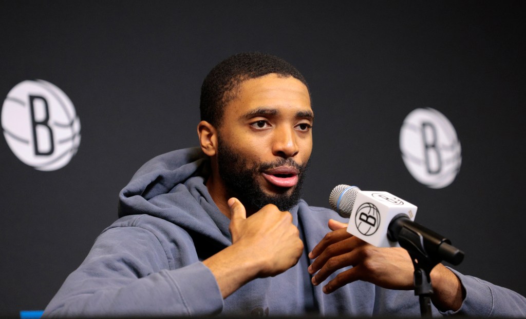 Brooklyn Nets forward Mikal Bridges speaking into a microphone at a press conference, expressing difficulty with the team's struggles