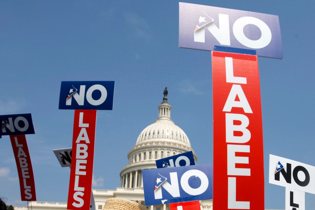 People with the group No Labels hold signs during a rally on Capitol Hill in Washington, July 13, 2013. 