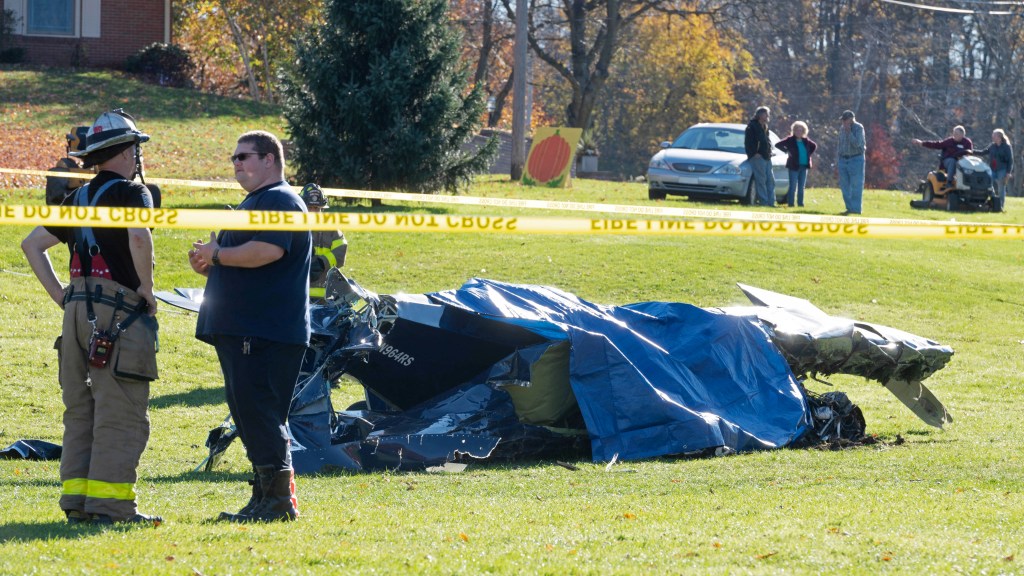 Emergency personnel wait for the coroner after a fatal small plane crash in a yard at Dorance Farm, where families were having hayrides and picking pumpkins for Halloween in Hanover Township, Pennsylvania, U.S. October 29, 2022