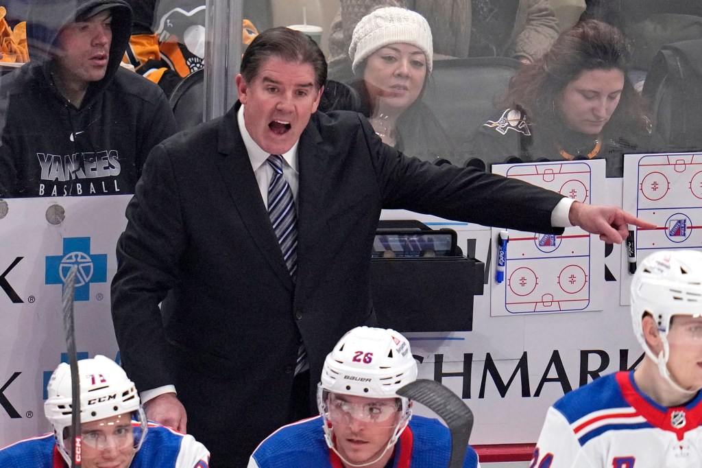 New York Rangers head coach Peter Laviolette makes his point to a linesman during the first period of an NHL hockey game against the Pittsburgh Penguins in Pittsburgh, Wednesday, Nov. 22, 2023. 