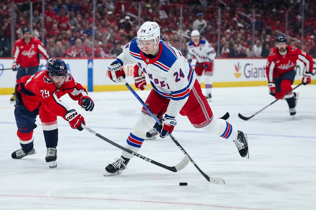 Kaapo Kakko of the Rangers shoots the puck in front of Hendrix Lapierre on Sunday.