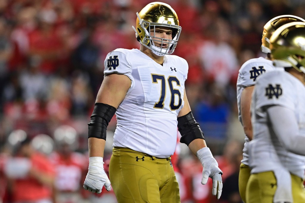 Notre Dame offensive lineman Joe Alt preparing for a play during a college football game against Ohio State