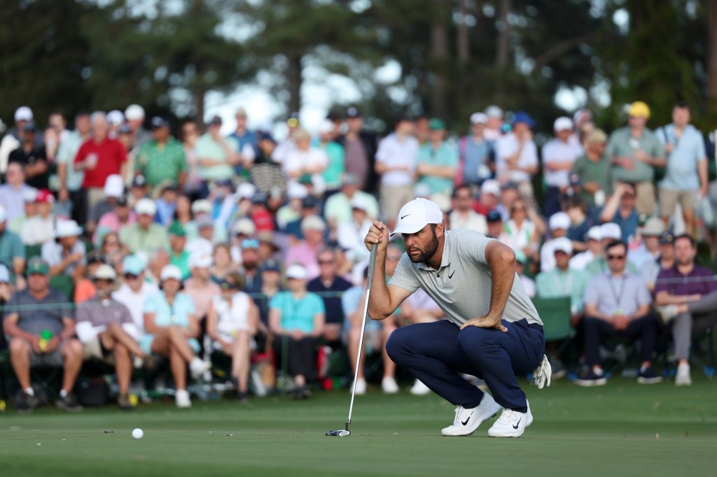 .Scottie Scheffler of the United States lines up a putt on the 18th green during the first round of the 2024 Masters Tournament at Augusta National Golf Club on April 11, 2024.