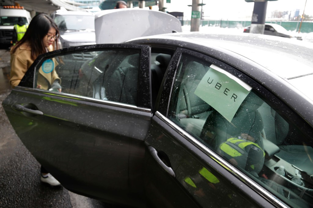  a passenger enters an Uber car