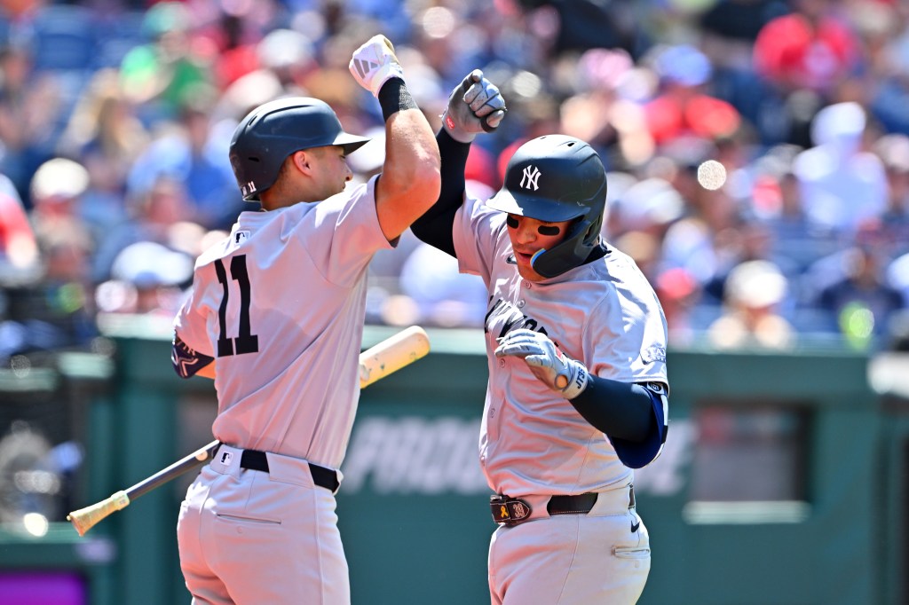 Anthony Volpe (11) celebrates with Jose Trevino.