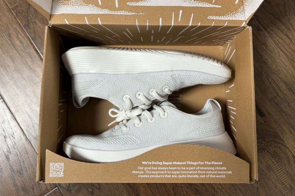 A pair of white sneakers in a box