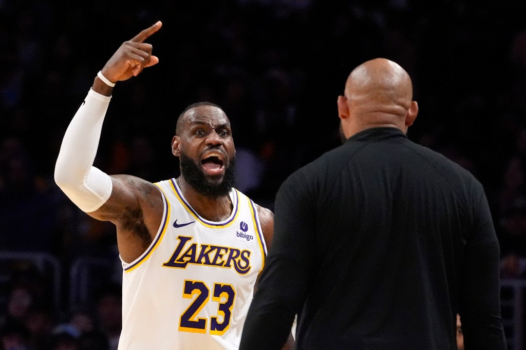 Los Angeles Lakers forward LeBron James, left, asks head coach Darvin Ham for a replay review after he was called for a foul during the second half in Game 4 of an NBA basketball first-round playoff series Saturday, April 27, 2024, in Los Angeles.