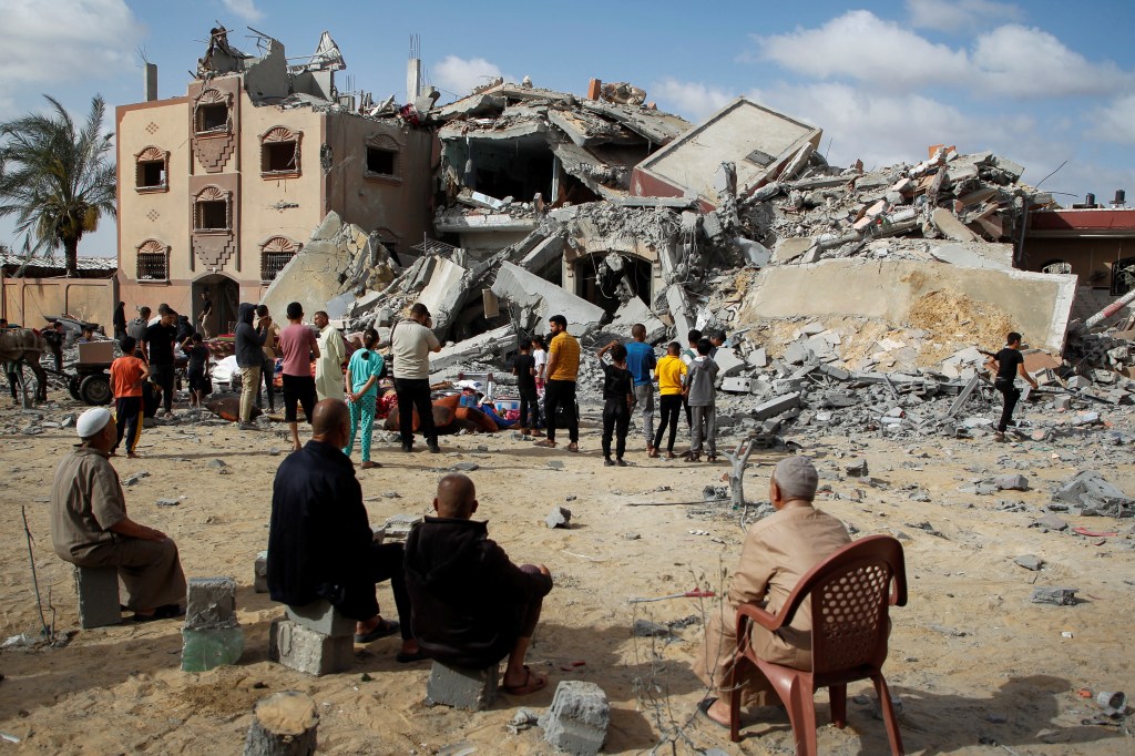 Palestinians inspecting the damage at the site of an Israeli strike on a house in Rafah on May 5, 2024.