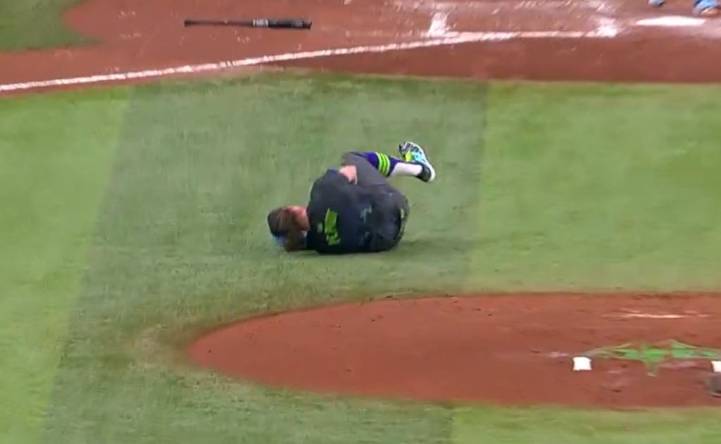 Rays pitcher Ryan Pepiot down on the ground after getting hit in the leg by a Starling Marte comebacker.