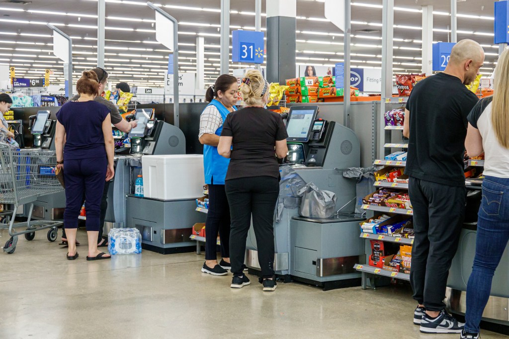 Miami, Florida, Doral, Walmart store, self service checkout, associate helping. 