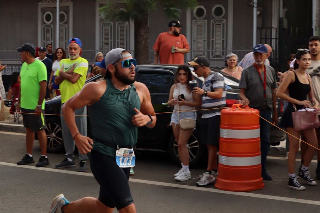 A man running in a race, post-weight loss surgery, fitting easily into a size Medium