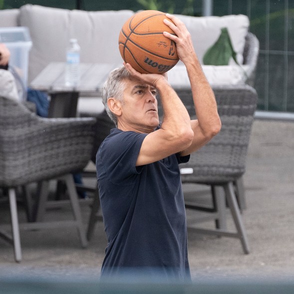 On his 63rd birthday, George Clooney takes time out of his filming schedule to shoot some hoops with co-star Adam Sandler in Milan, Italy.