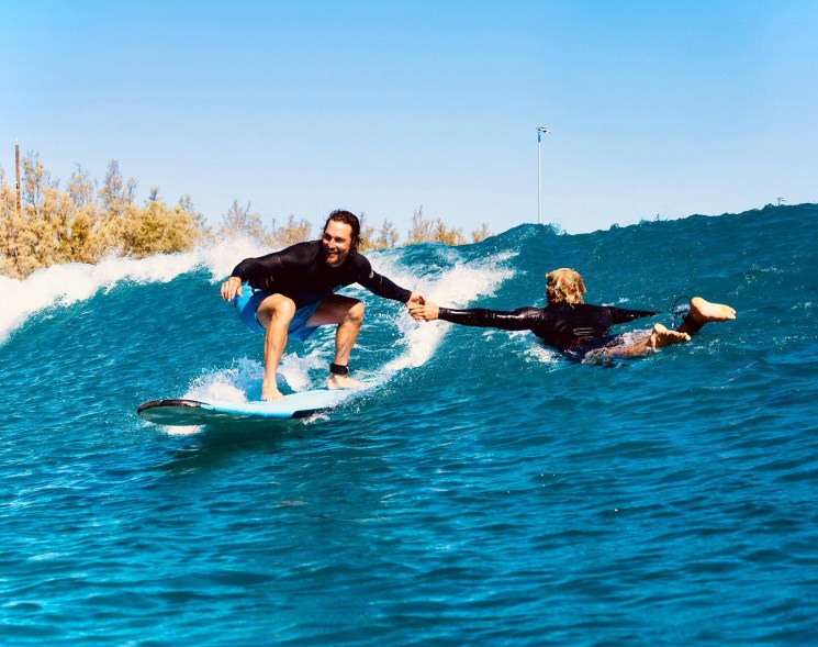 BOARD CERTIFIED: Matthew McConaughey (left) lets his buddy catch a ride after the surf gets the better of him.