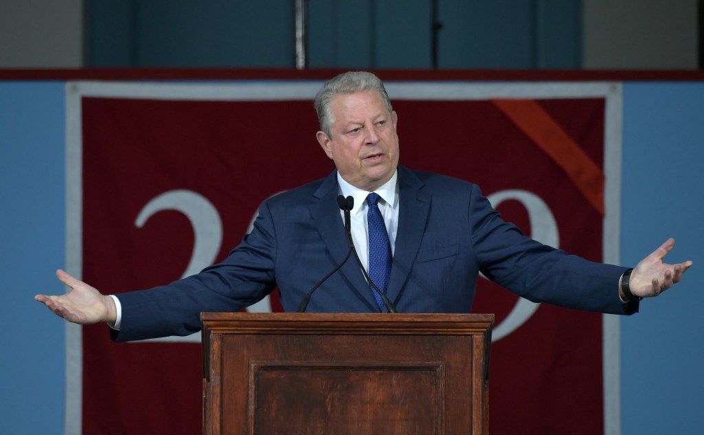 Former Vice President Al Gore speaking at the podium during the 2019 Harvard Class Day event