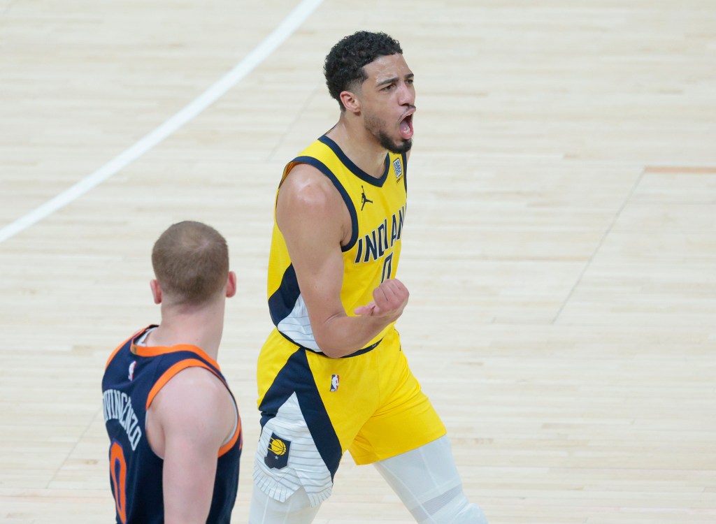 Tyrese Haliburton #0 of the Indiana Pacers reacts after scoring along side Donte DiVincenzo #0 of the New York Knicks during the second quarter.