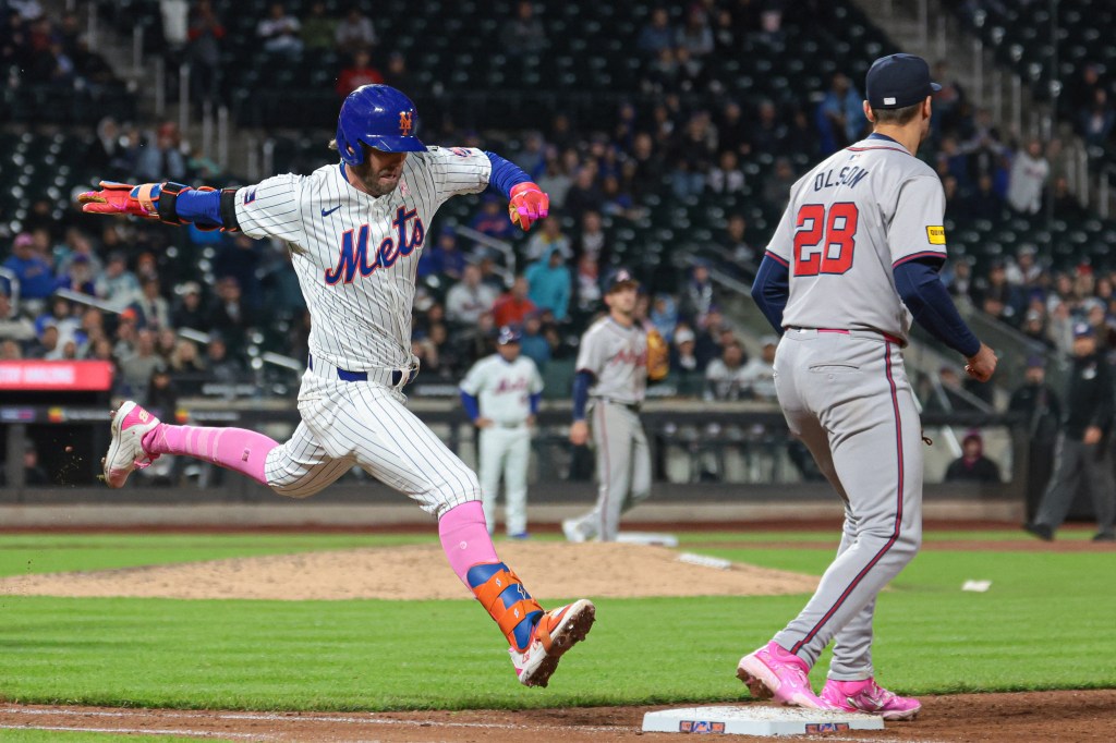 Jeff McNeil bunts for a hit during the ninth inning of the Mets' win over the Braves on May 12, 2024.