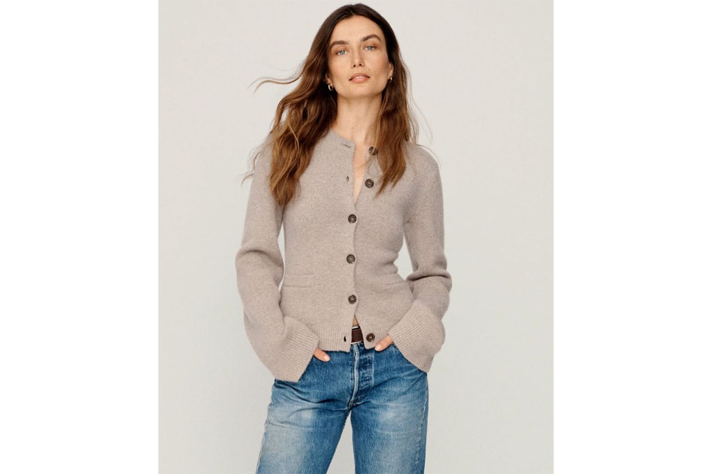 Andreea Diaconu, a woman with long hair, wearing a cardigan and jeans