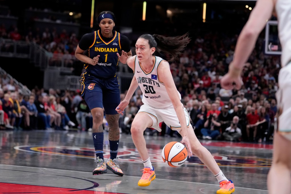 New York Liberty forward Breanna Stewart (30) drives to the basket past Indiana Fever forward NaLyssa Smith (1) in the first half of a WNBA basketball game, Thursday, May 16, 2024, in Indianapolis.