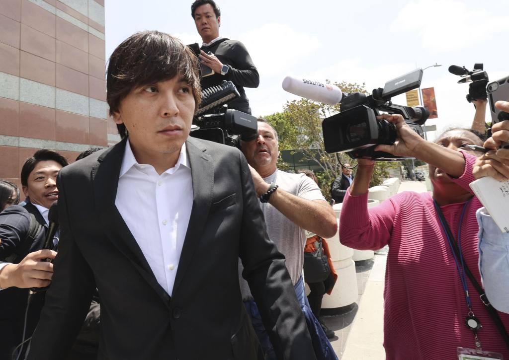 Ippei Mizuhara, the former interpreter for Los Angeles Dodgers star Shohei Ohtani, is surrounded by the media in front of a federal district court in Los Angeles on May 14, 2024, after attending a court hearing over two charges including bank fraud in connection with the theft of nearly $17 million of the two-way baseball player's money. 