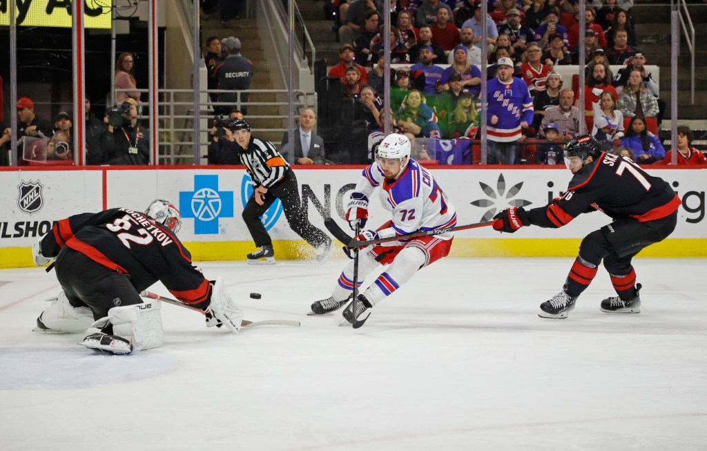 Pyotr Kochetkov #52 of the Carolina Hurricanes defends the net against Filip Chytil #72 of the New York Rangers as Brady Skjei #76 of the Carolina Hurricanes tries to block during the third period.