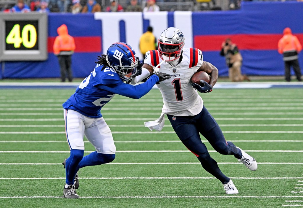 DeVante Parker (1) stiff arms New York Giants cornerback Deonte Banks (25) during the second quarter at MetLife Stadium in East Rutherford, N.J.