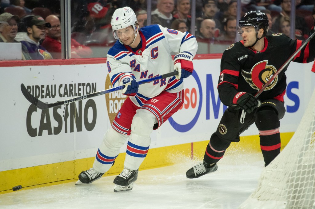 Jacob Trouba (8) moves the puck away from  Ottawa Senators center Josh Norris (9) in the first period at the Canadian Tire Centre on Dec. 5, 2023.