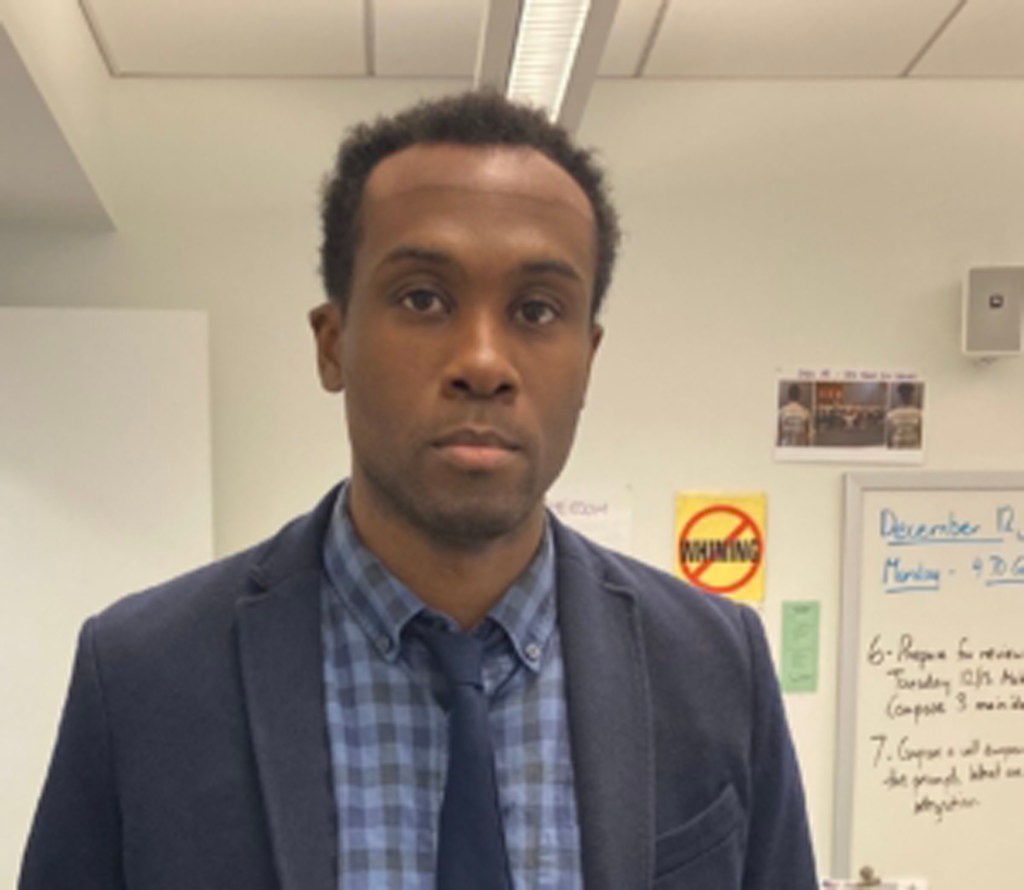 Dwayne Alexis, a Collegiate School teacher dressed in a suit and tie, offering Middle School Tutoring Services in NYC