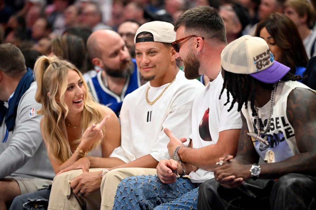 Chiefs quarterback Patrick Mahomes with his wife 
Brittany Mahomes (left) and tight end Travis Kelce (center) and Marquise Brown (right) during Game 3 of the NBA Western Conference Final in Dallas.