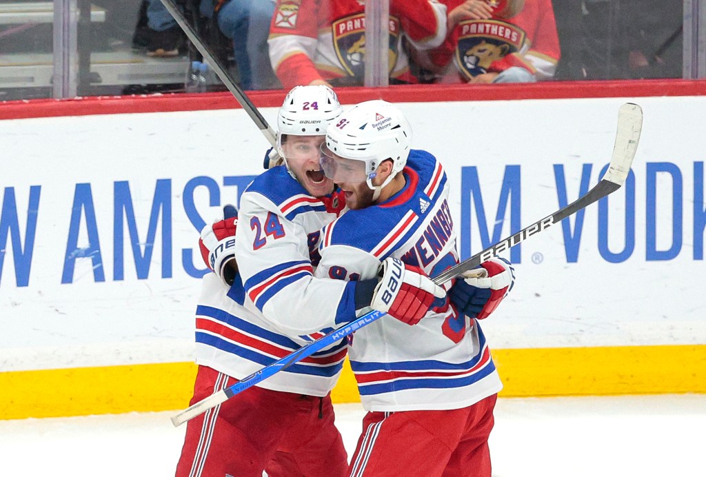 Kaapo Kakko, left, celebrates with Alex Wennberg after Wennberg scored the game-winning goal in overtime of Game 3 on Sunday in Sunrise, Fla.